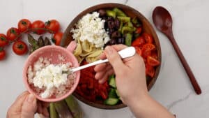 vegan feta being spooned over salad
