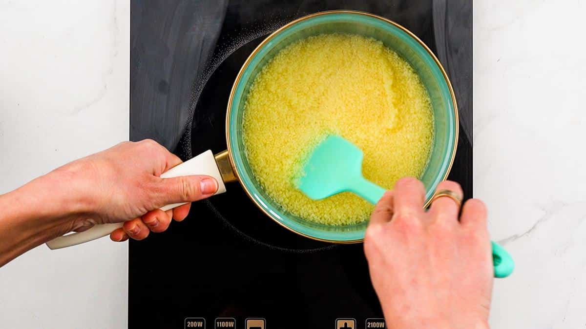 teal pan of couscous on hot plate