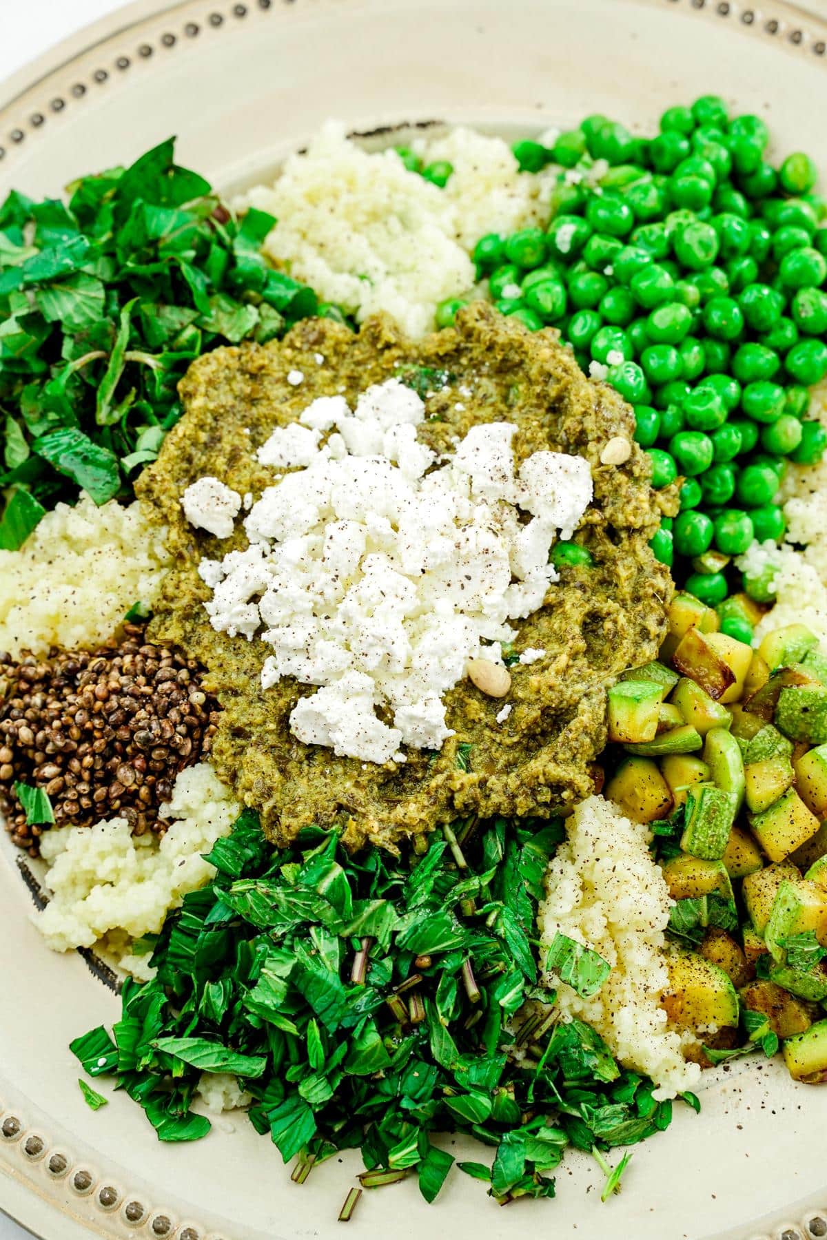 couscous salad ingredients in cream bowl before mixing