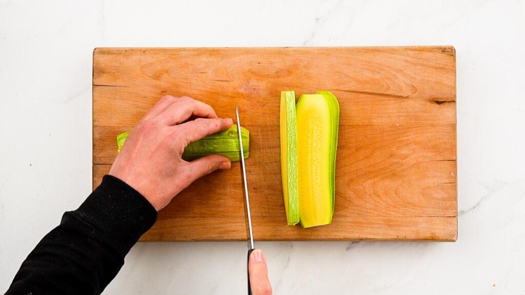 slicing zucchini on cutting board