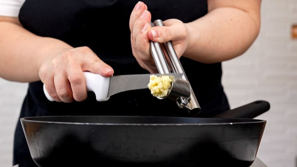 garlic being mined into pan