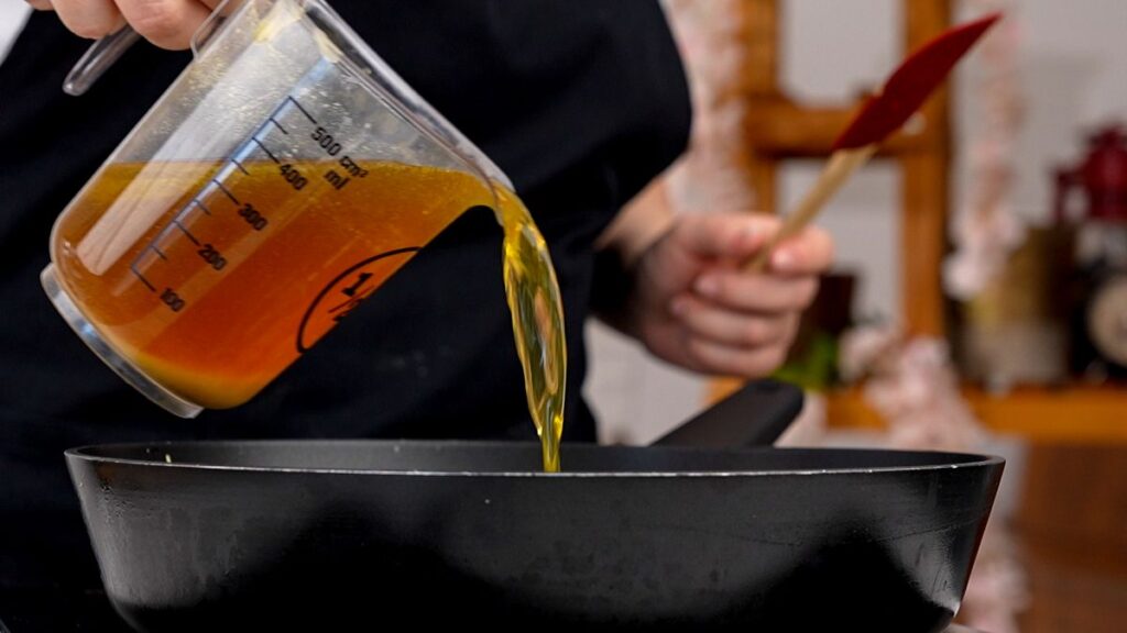 broth being poured into wok
