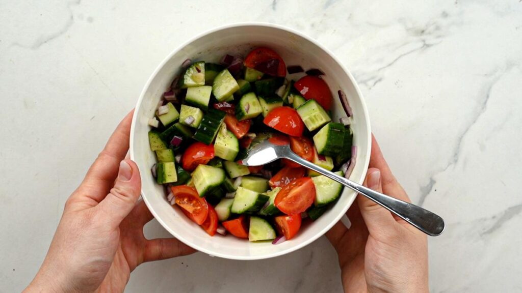 cucumber and tomatoes in white bowl