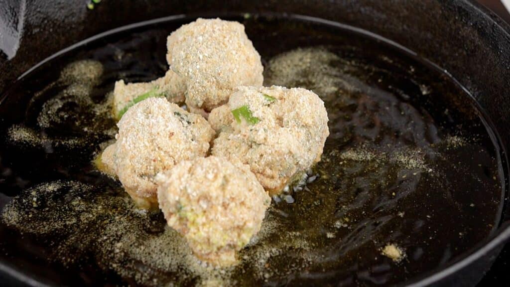 broccoli balls in skillet of oiil