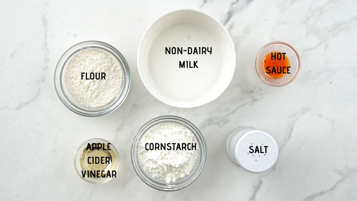 ramekins and glass bowls of ingredients on marble table