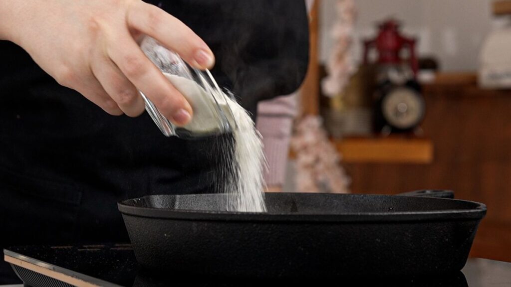 flour being poured into skillet