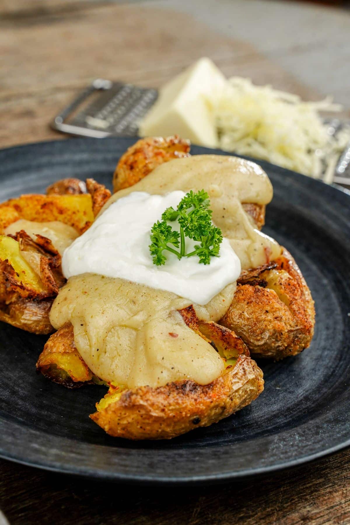 black plate of fiesta potatoes topped by sauces