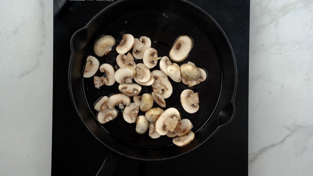 mushrooms in skillet on hot plate