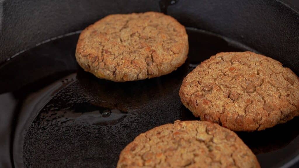 lentil patties being placed into skillet