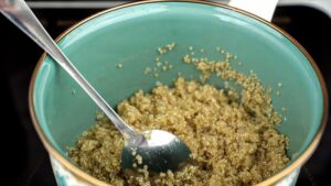 blue saucepan of quinoa with spoon