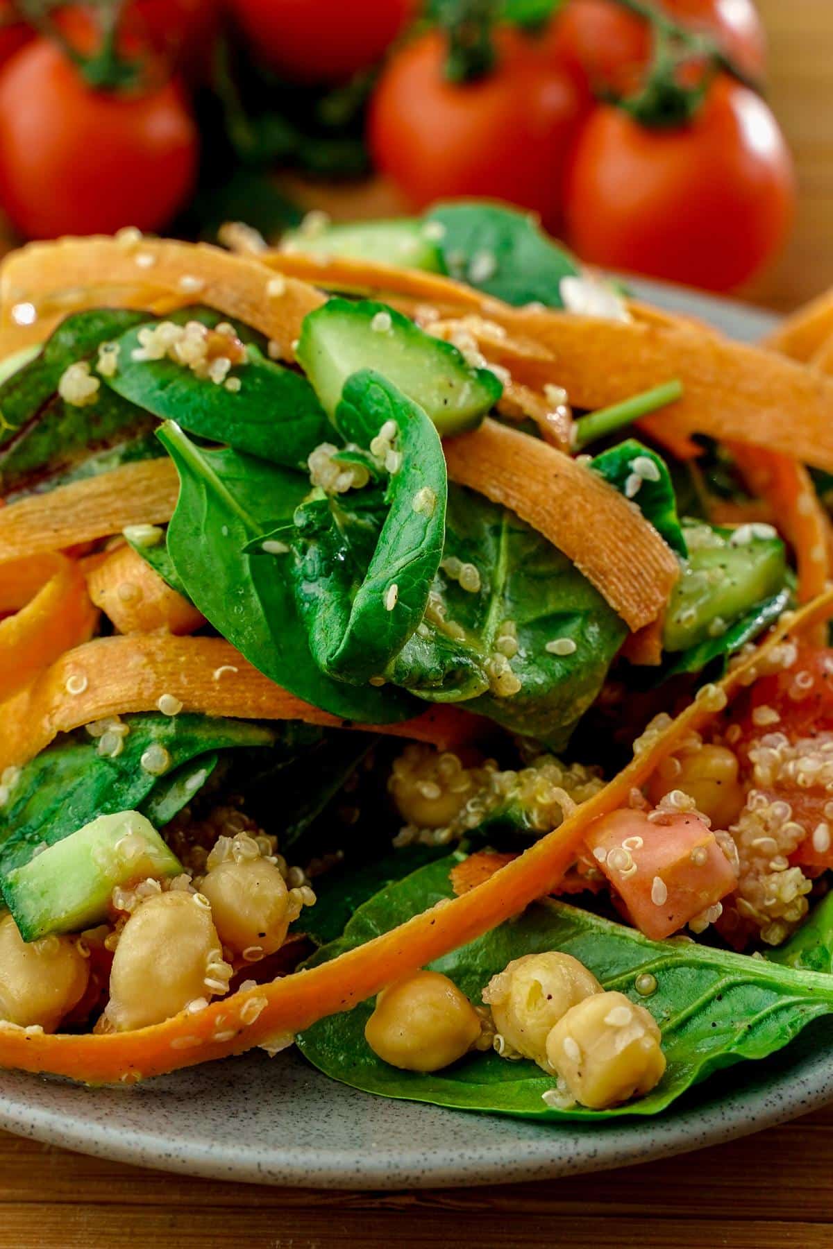 gray plate of rainbow salad with sliced carrots