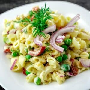 white bowl of vegan tuna pasta salad on gray table