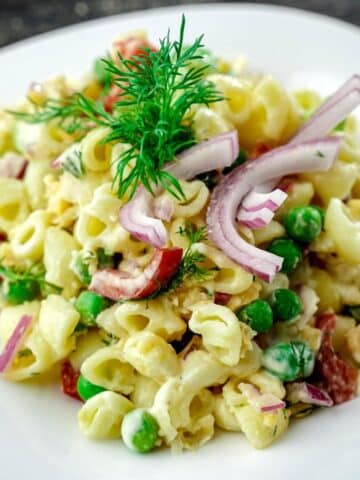 white bowl of vegan tuna pasta salad on gray table