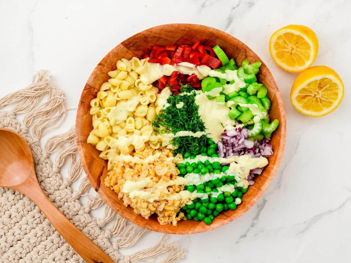 wood bowl of salad on white marble table