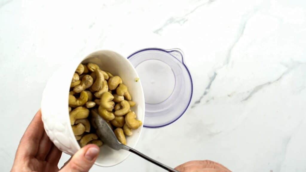 pouring cashews into blender