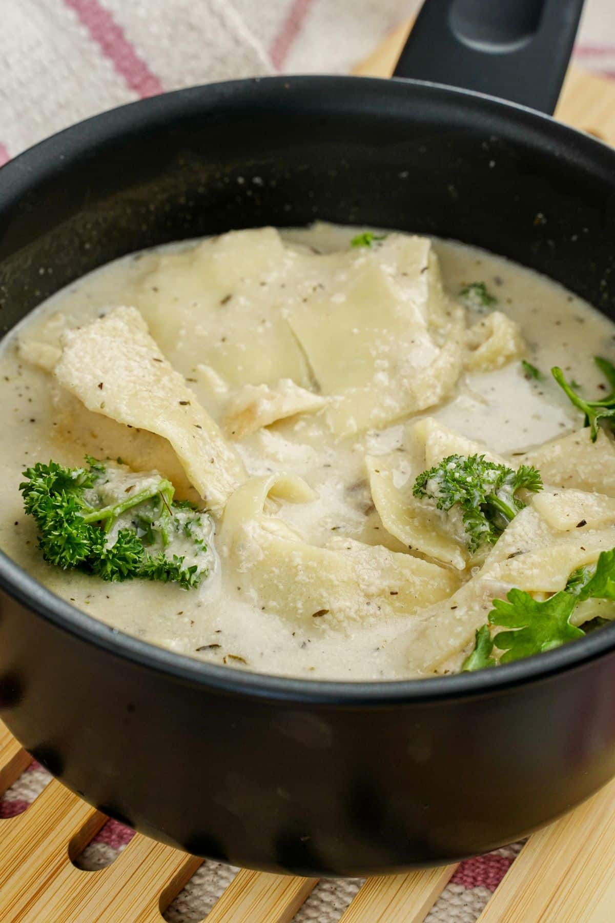 black saucepan of vegan white lasagna soup