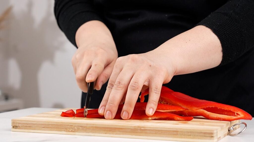 red bell pepper being sliced
