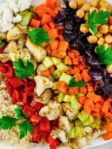 rice on plate topped with roasted vegetables