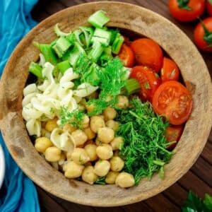 Easy vegan pesto salad served in a wooden bowl.