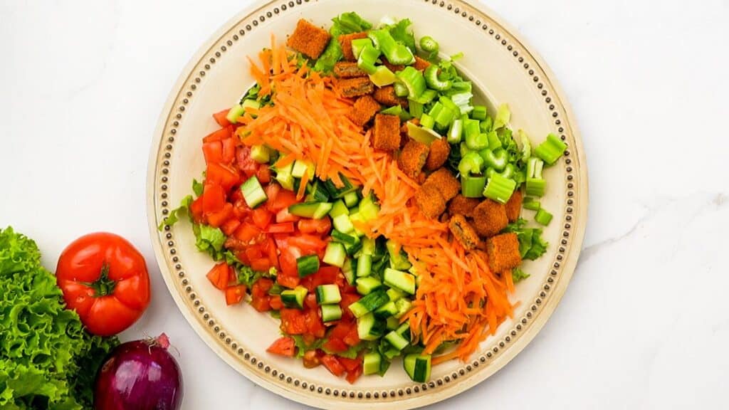 cream plate of salad with shredded carrots