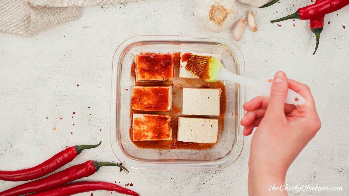 tofu being marinated in glass baking dish