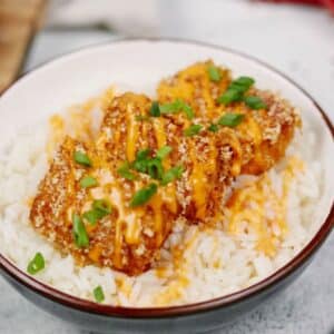 cream late with red rim of rice topped by breaded tofu