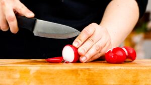 slicing radish on cutting board