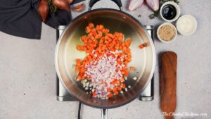 skillet on hot plate holding carrots and shallots