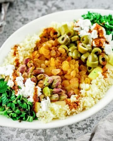 oval white platter of morroccan couscous salad