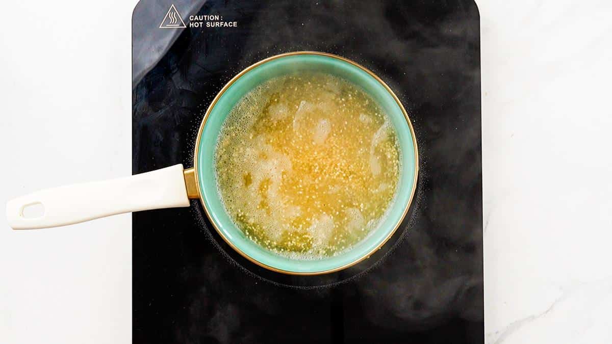 quinoa being cooked in small blue saucepan