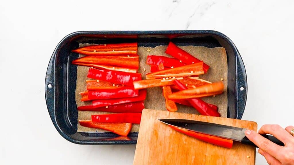 sliced red peppers on baking sheet