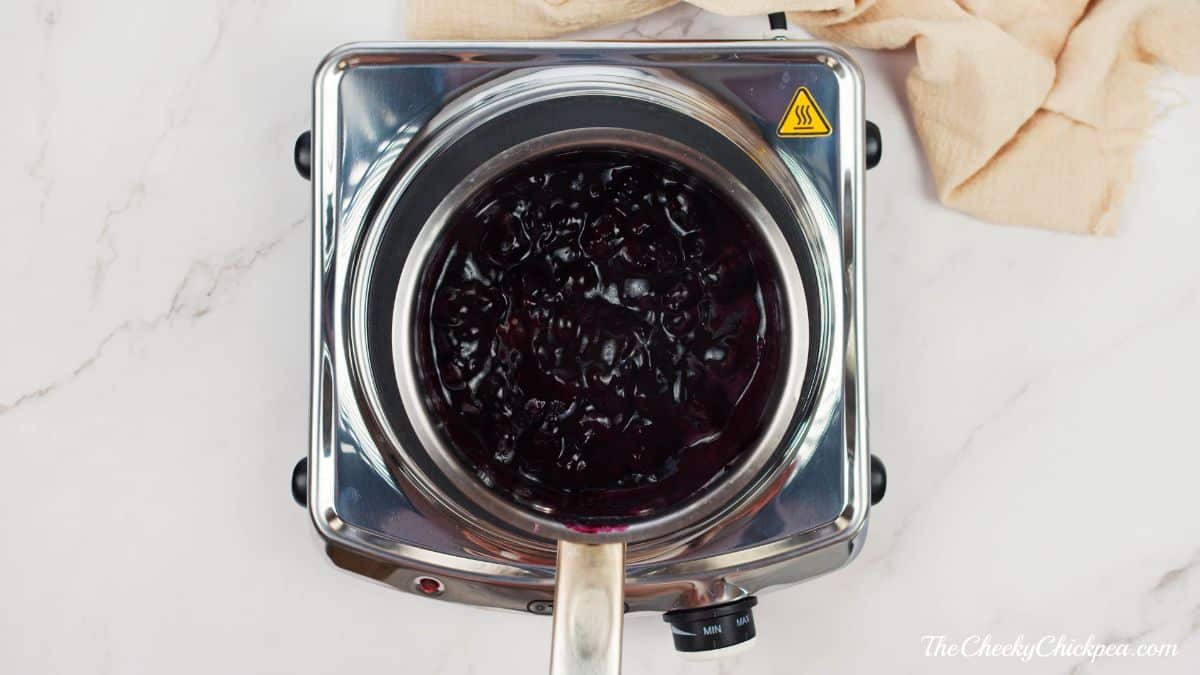 blueberries boiling on stovetop in pan