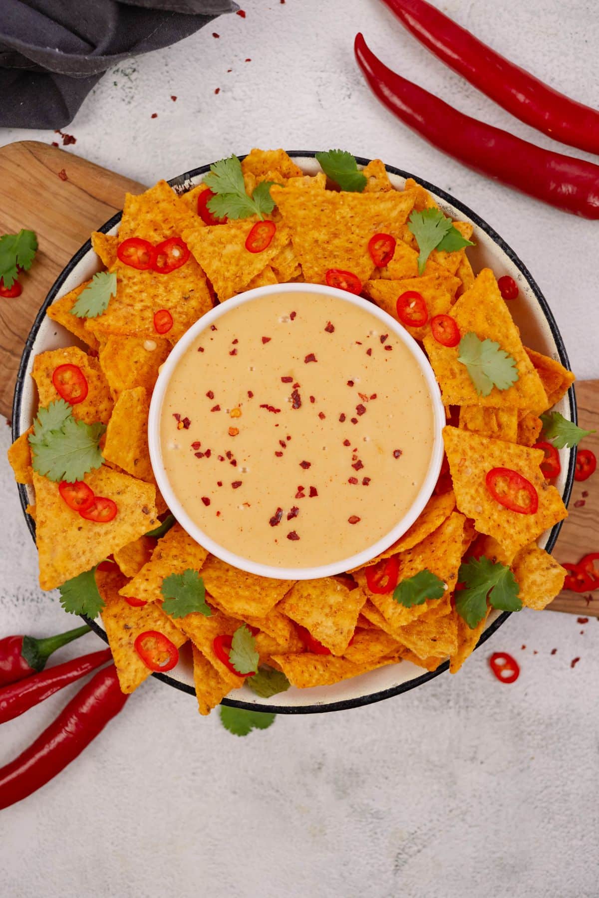 platter of chips with bowl of vegan cheese sauce in center