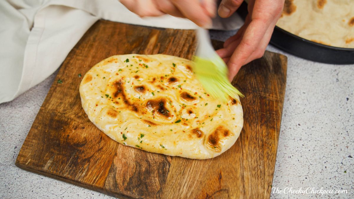 brushing top of naan with oil
