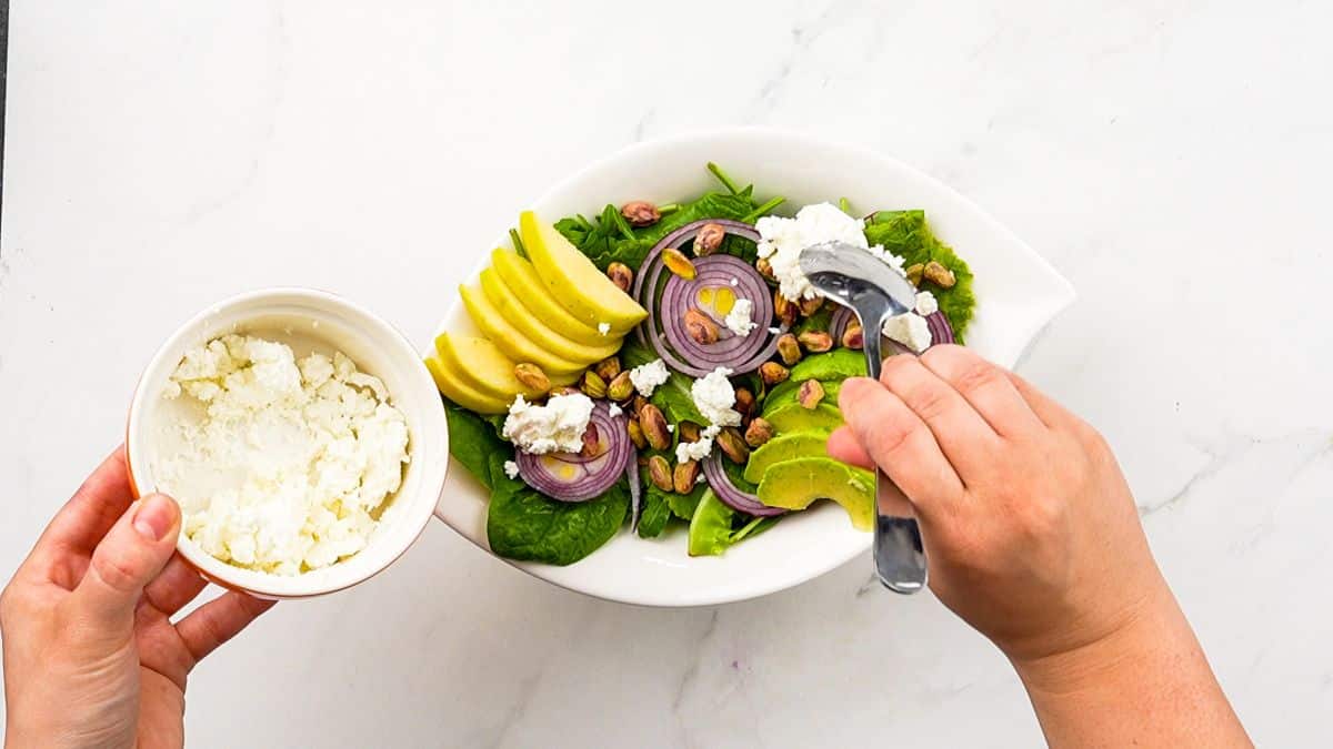 layering vegetables in bowl for salad