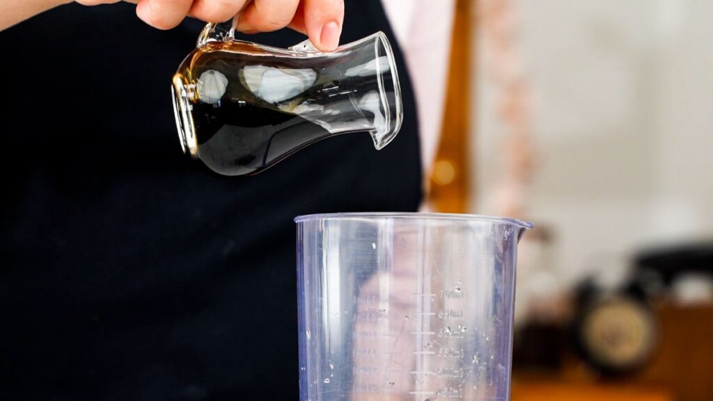 oil being poured into jar for salad dressing