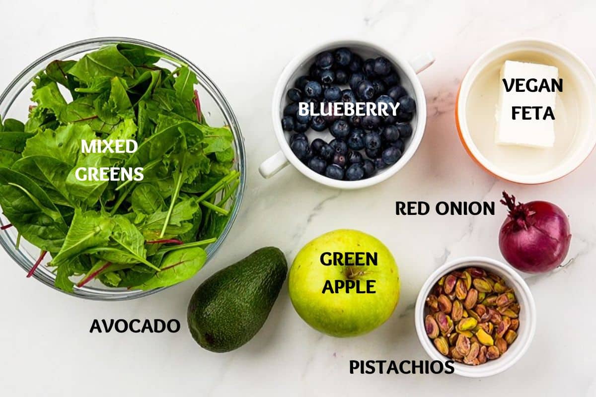 vegetables and fruit in bowls on white table