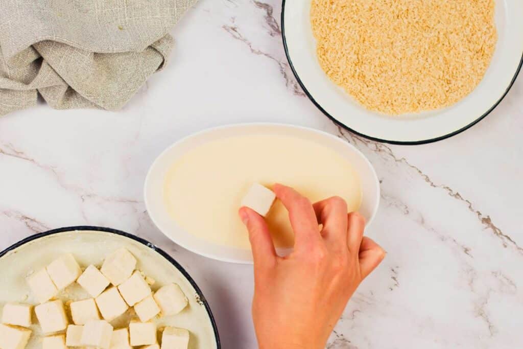 tofu cubed dipping into milk