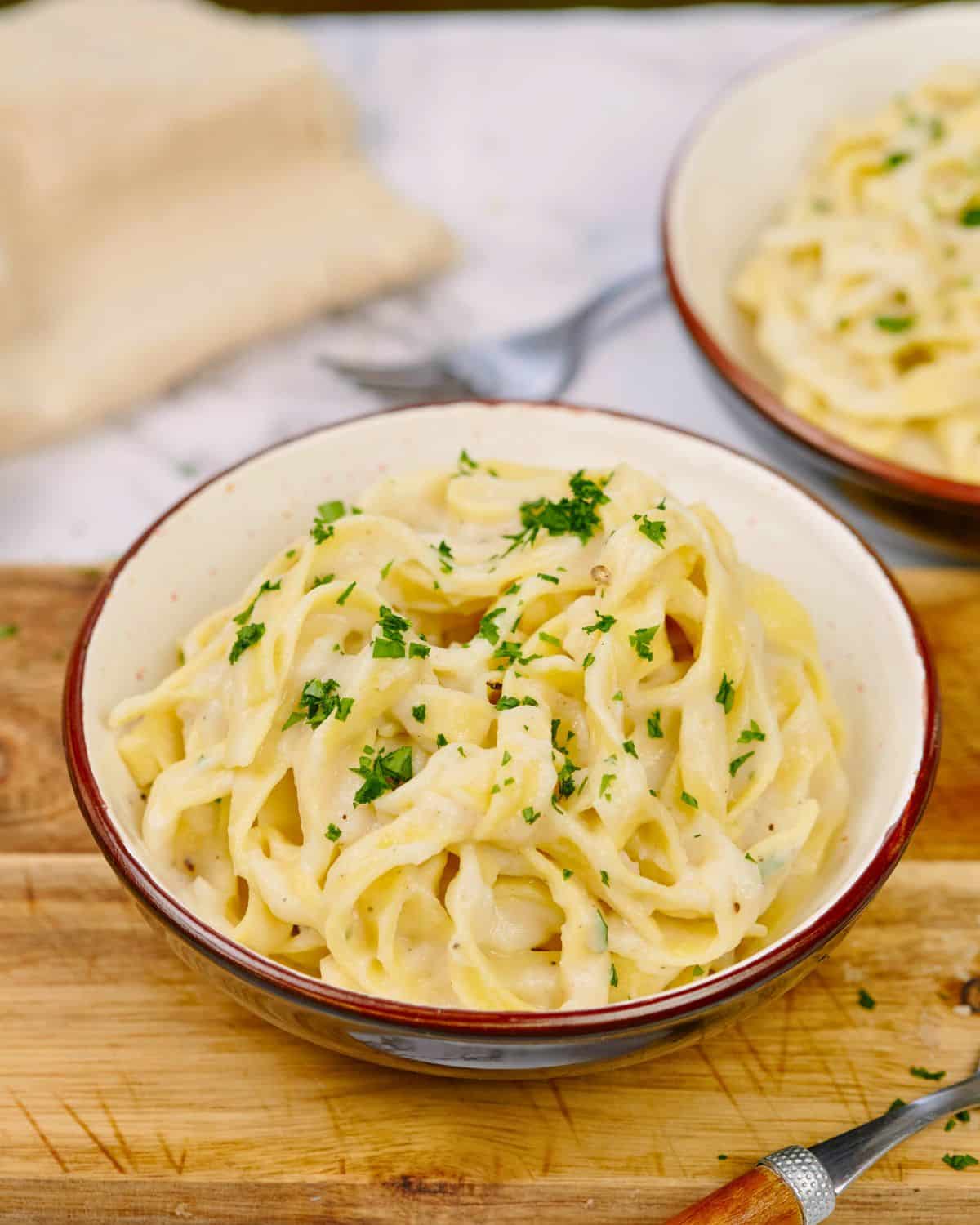 bowl of pasta on cutting board