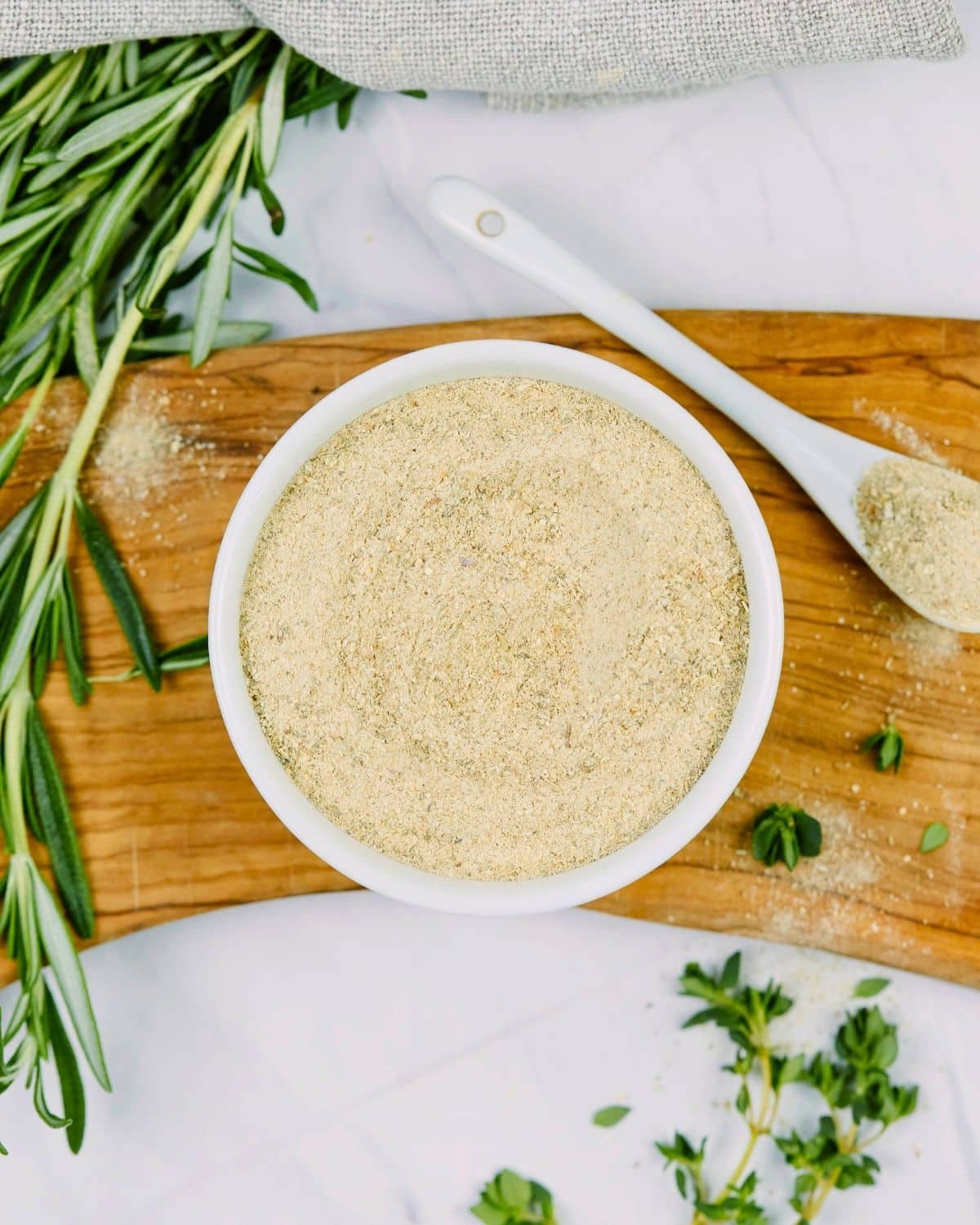 bouillon in small ramekin by fresh herbs