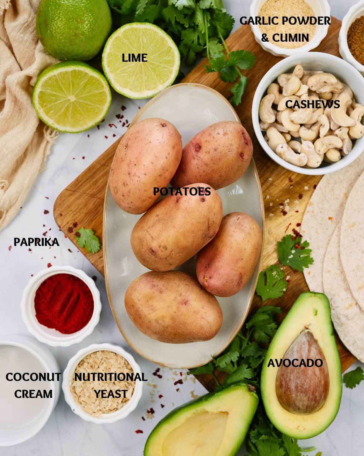 fresh potatoes and avocado on table with ingredients for fried potato tacos