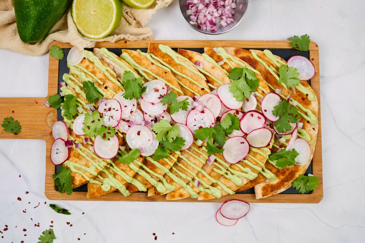 rectangular cutting board with tacos on top