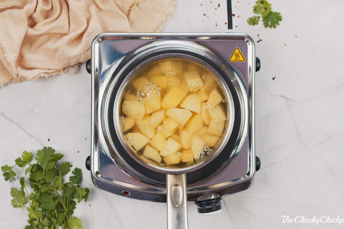 saucepan of potatoes on hot plate