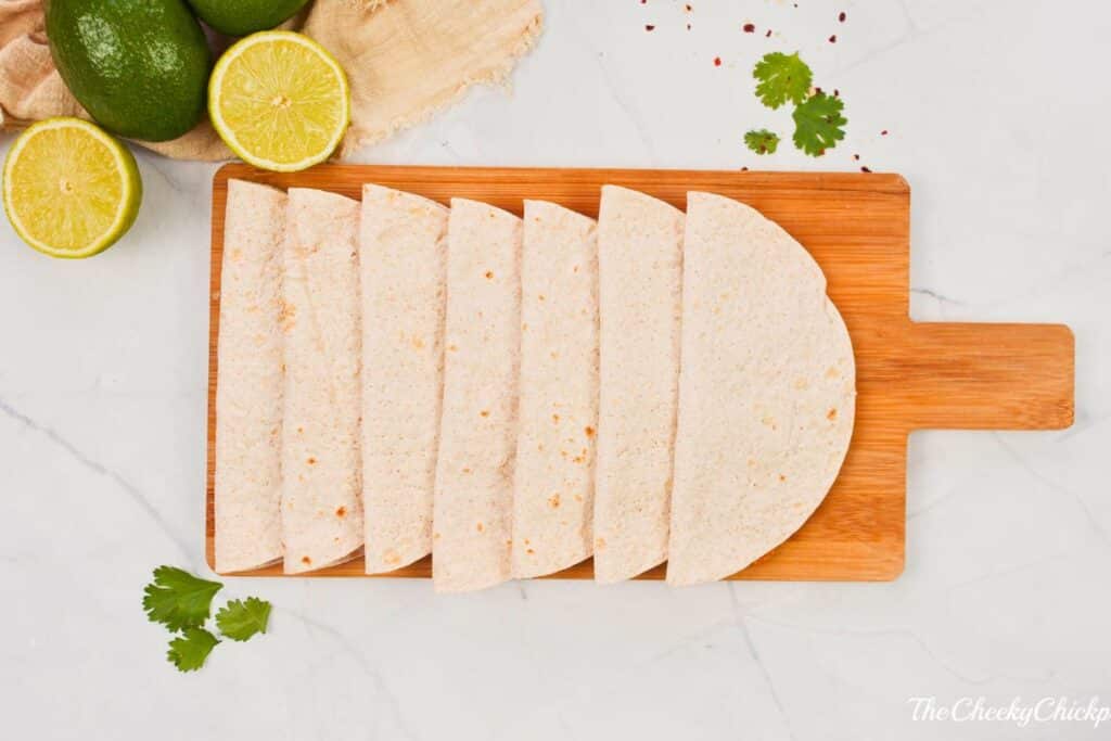 folded tortillas on cutting board