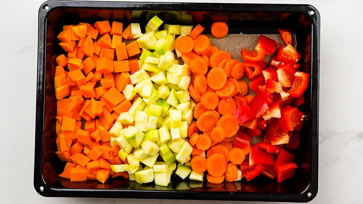 vegetables in layers on baking sheet
