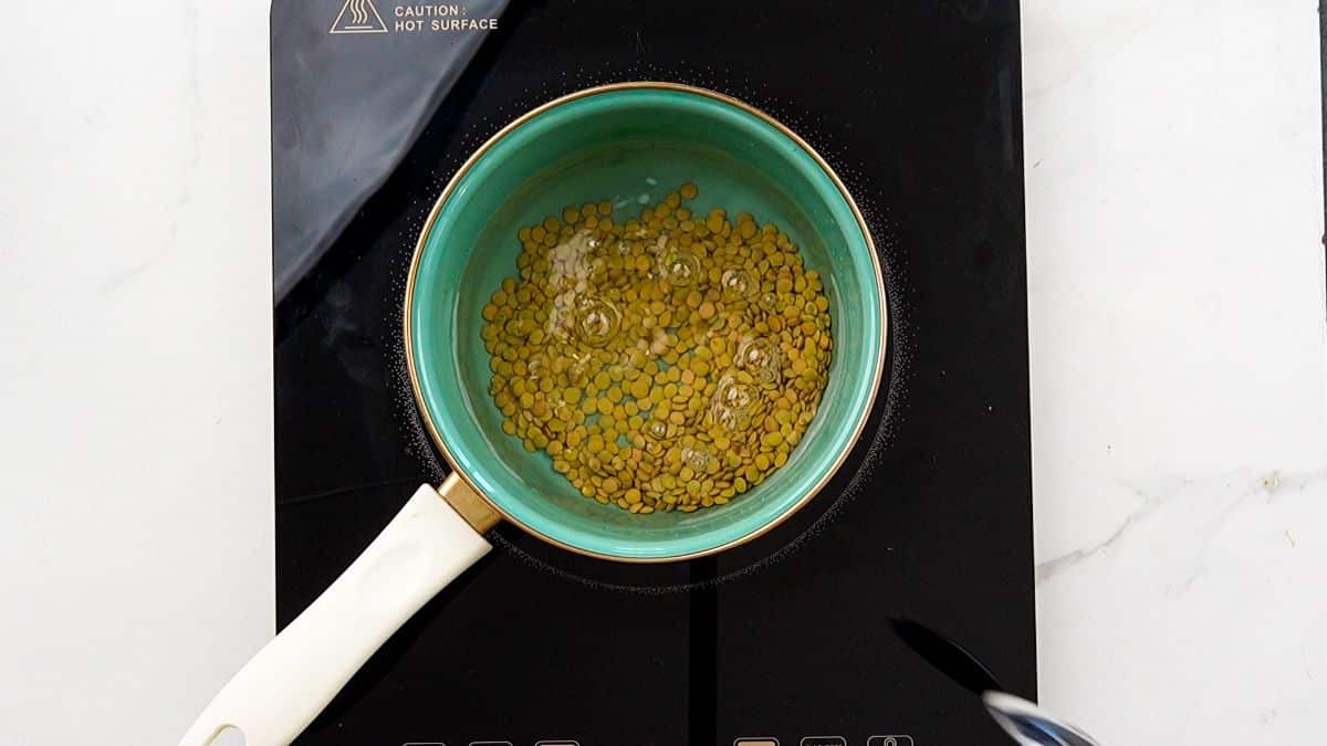 quinoa in teal saucepan on black hot plate