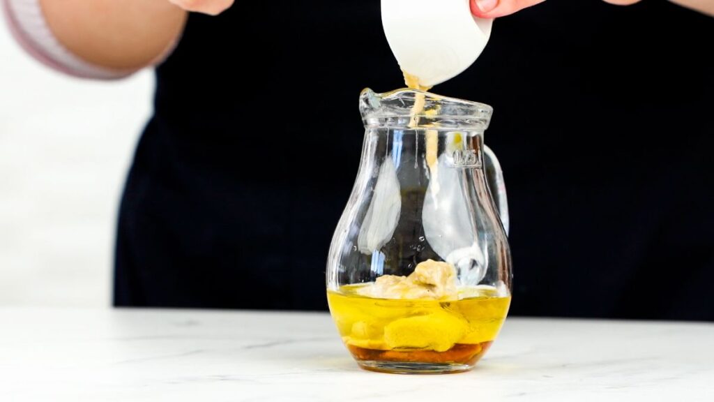 oil being poured into glass jar