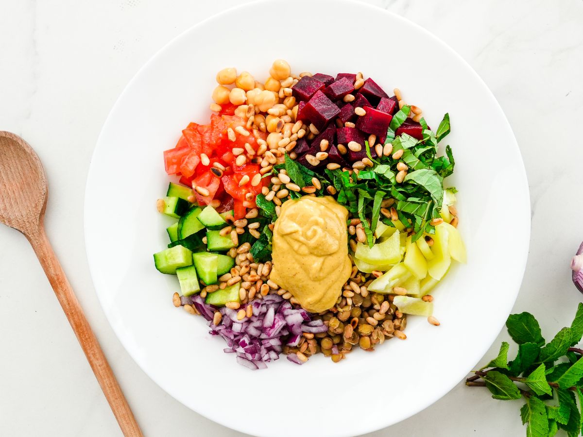 bowl of salad with bright vegetables on top