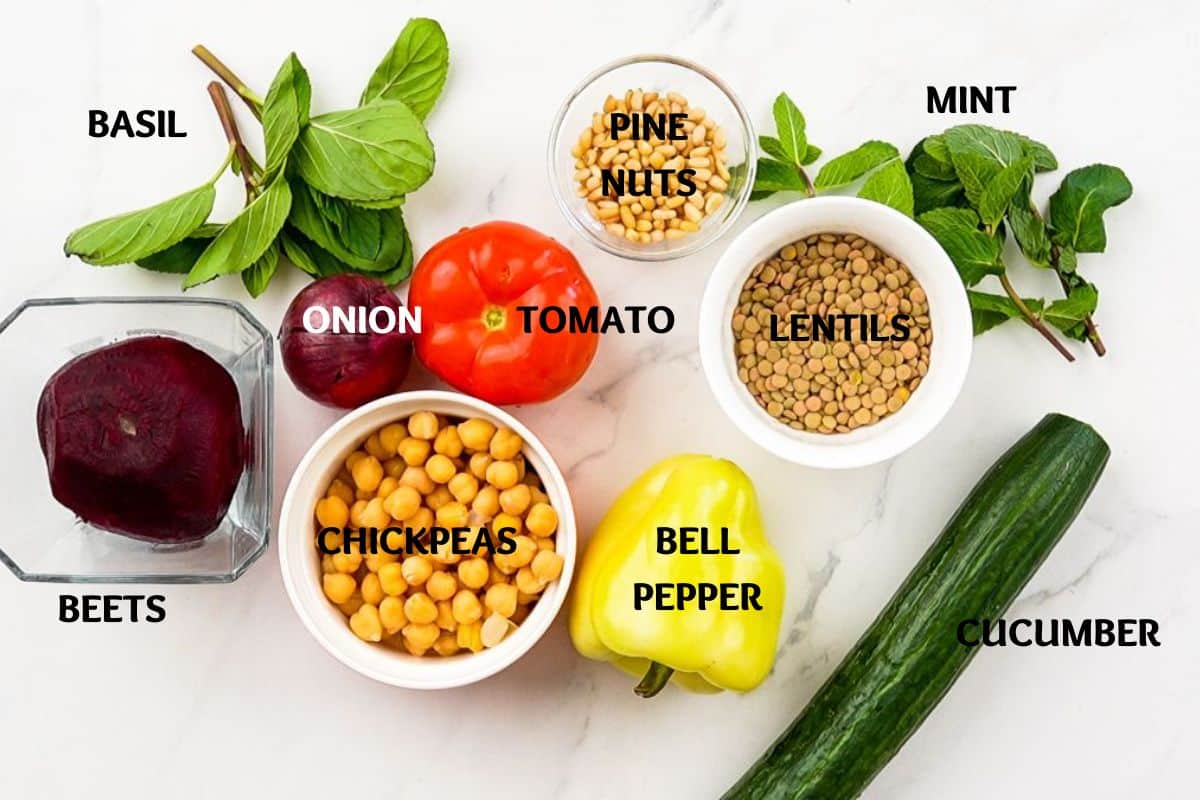 vegetables, lentils, and chickpeas in bowls on marble table