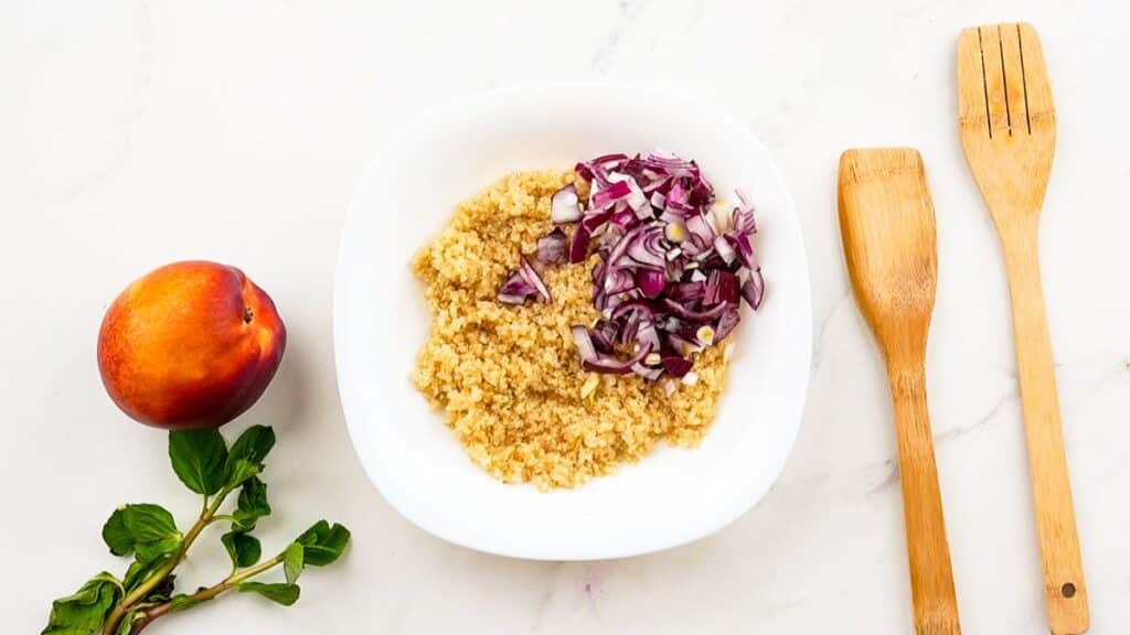 quinoa in white bowl with red cabbage on top
